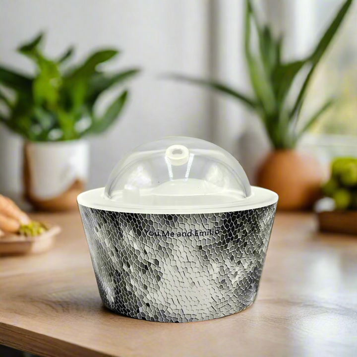 Decorative container with a textured design and glass dome on a white background