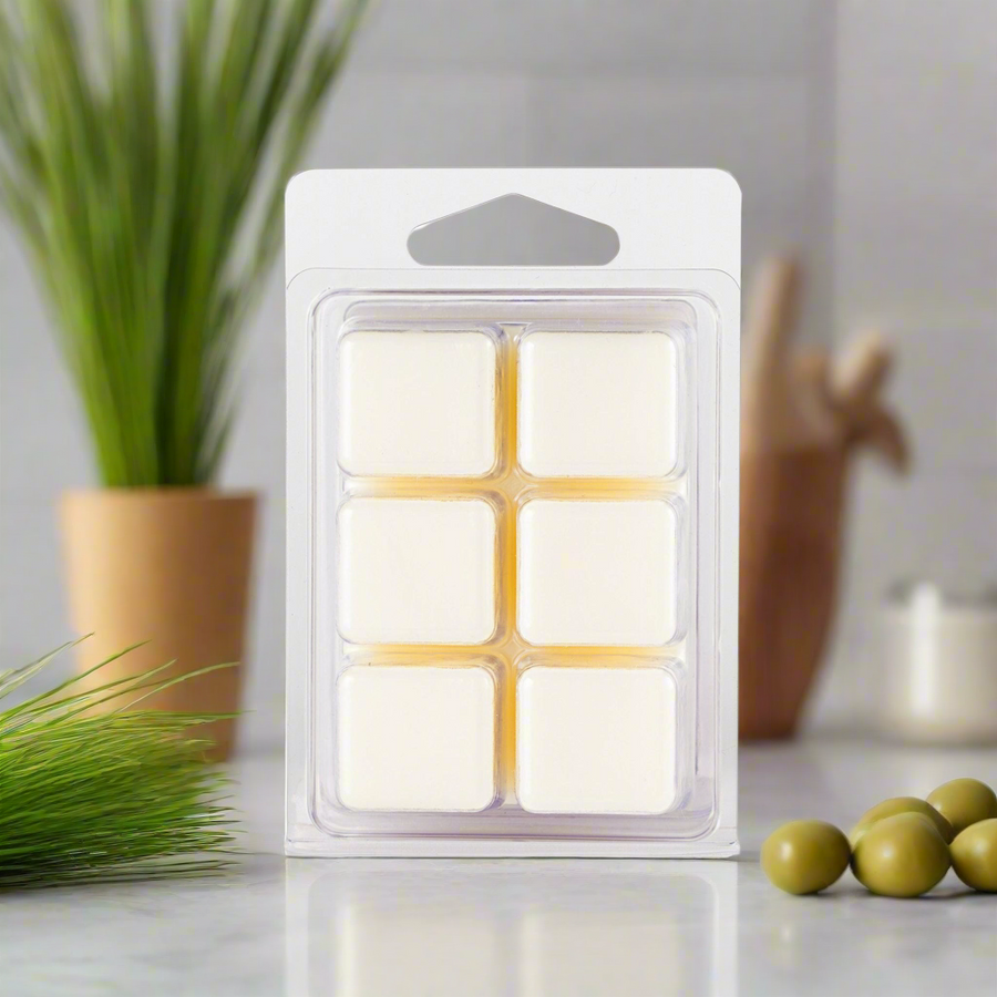 Pack of wax melts on a kitchen counter with plants and jars in the background