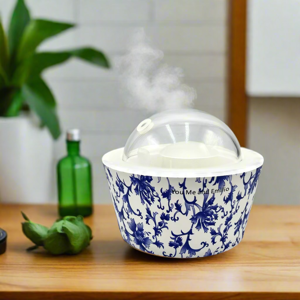 White container with blue floral pattern and a clear dome lid on a white background