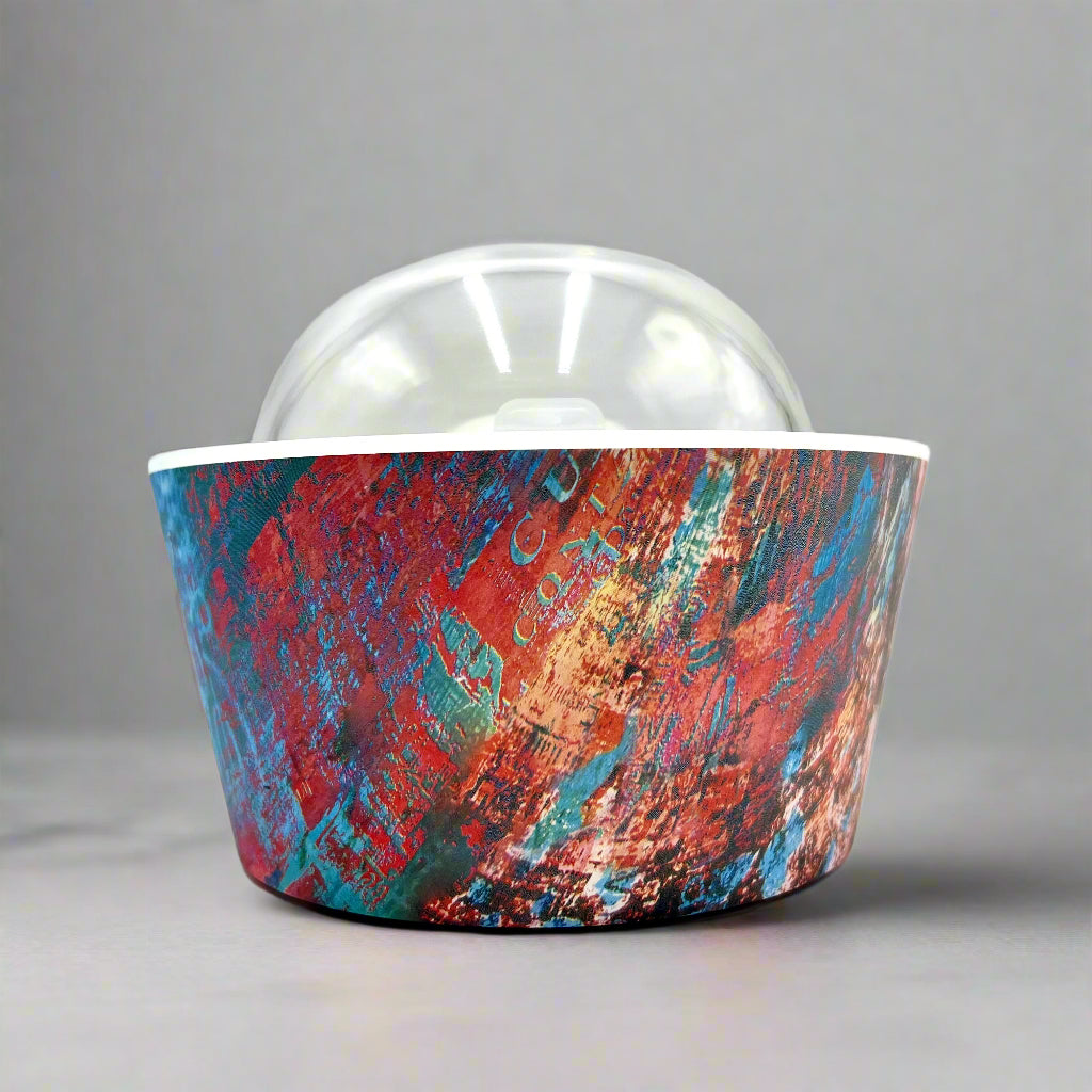 Artistic Essence Oil Diffuser, a masterful creation from Emilio Horton, founder of YOU ME &amp; EMILIO. Featuring a vibrant, textured abstract design of deep blues, fiery reds, and shimmering gold, this diffuser transforms any space into a sanctuary of creativity, relaxation, and sensory delight.

More than just an aromatherapy tool, the Artistic Essence brings an immersive experience with the gentle sound of running water and soft mist creation, inspired by the tranquility of natural streams.
