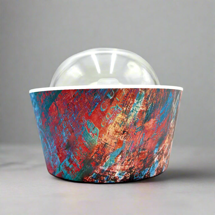 Artistic Essence Oil Diffuser, a masterful creation from Emilio Horton, founder of YOU ME &amp; EMILIO. Featuring a vibrant, textured abstract design of deep blues, fiery reds, and shimmering gold, this diffuser transforms any space into a sanctuary of creativity, relaxation, and sensory delight.

More than just an aromatherapy tool, the Artistic Essence brings an immersive experience with the gentle sound of running water and soft mist creation, inspired by the tranquility of natural streams.