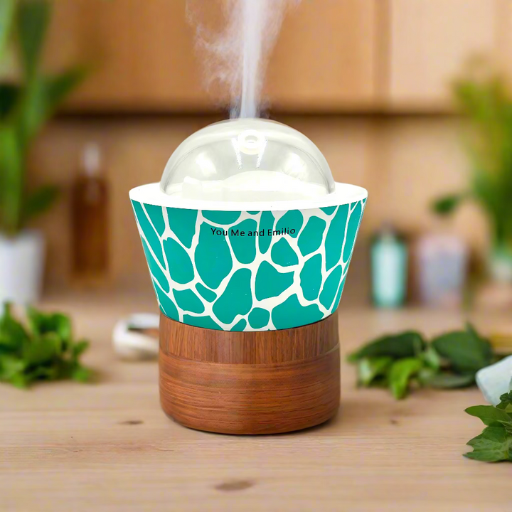 Teal and white patterned container with a clear dome lid on a white background