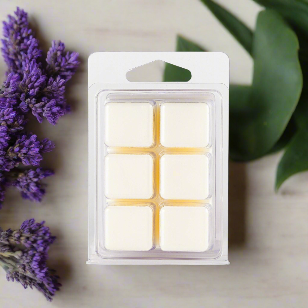 Packaged wax melts with lavender flowers and green leaves on a neutral background
