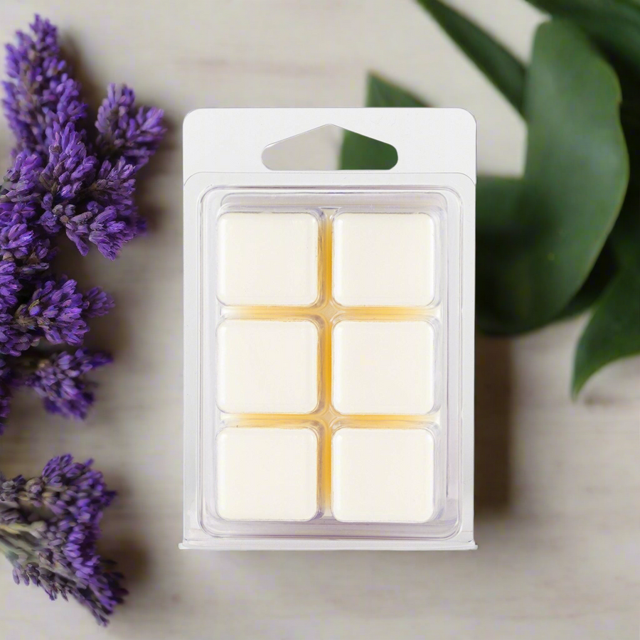 Packaged wax melts with lavender flowers and green leaves on a neutral background