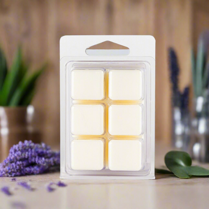 Pack of wax melts with a wooden background and plants