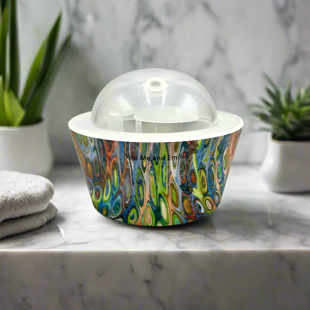 Colorful patterned container with a clear dome lid on a white background