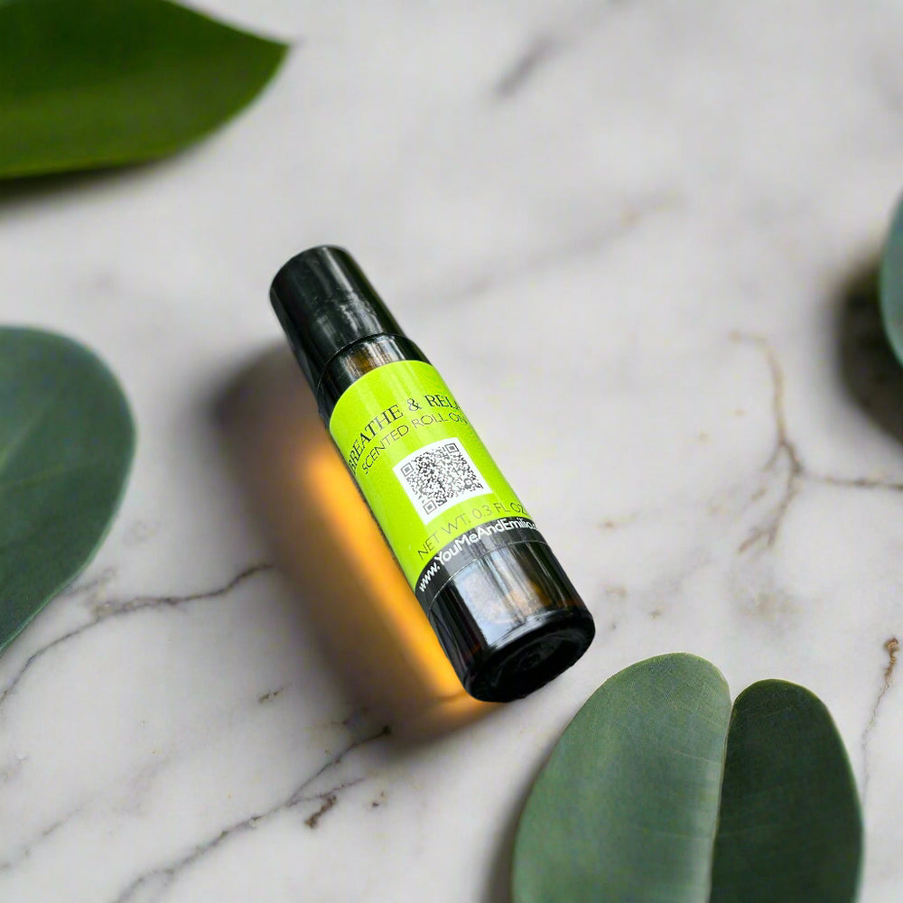 Breathe & Relax Scented Roll-On by You Me & Emilio in amber glass bottle, featuring eucalyptus and spearmint aromatherapy fragrance oil for relaxation.