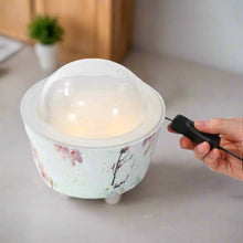 Close-up of the Cherry Blossom Diffuser with a sleek design and natural elements, inspired by the flow of water.