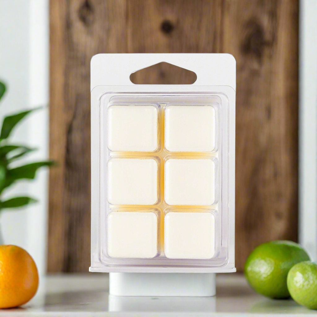 Packaged wax melts with a wooden background and fruits on a surface