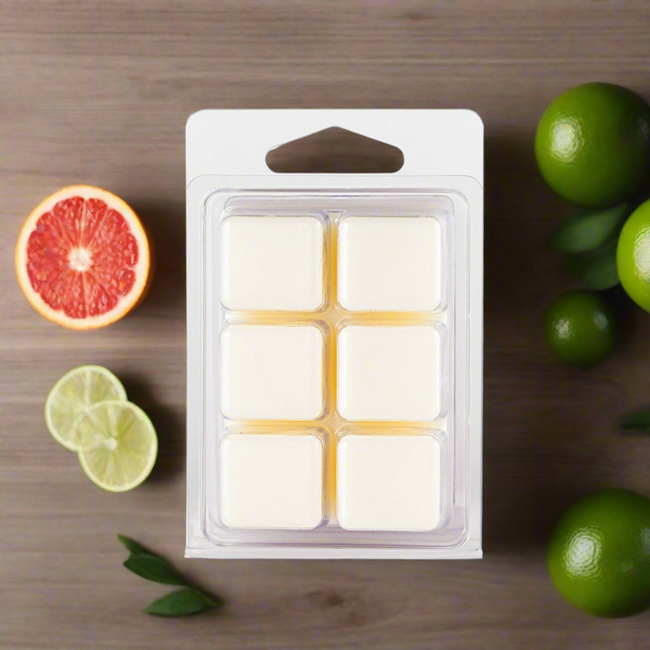 Pack of wax melts with citrus fruits on a wooden surface