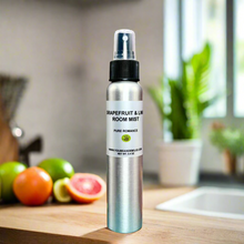 Grapefruit & Lime Room Mist showcased alongside fresh lime and grapefruit slices, representing its revitalizing citrus scent.