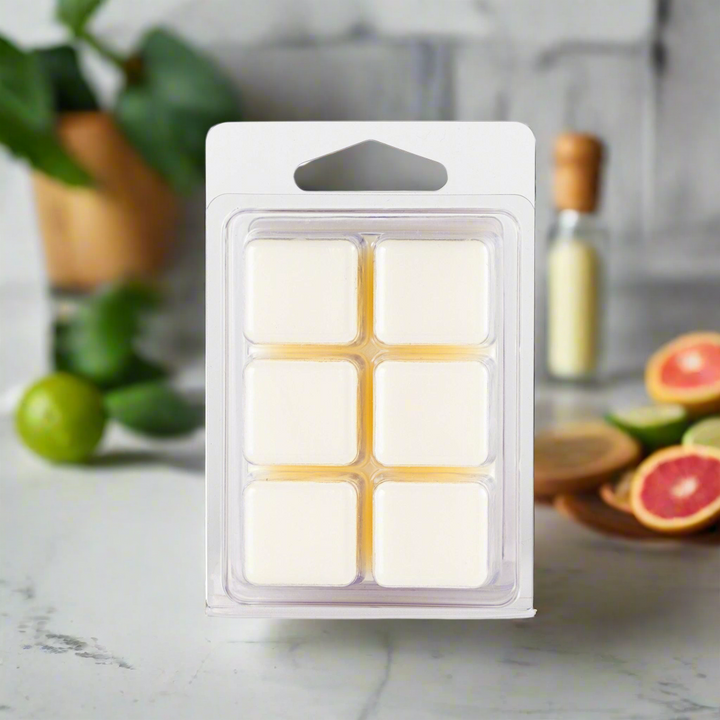 Pack of wax melts on a kitchen counter with fruits in the background
