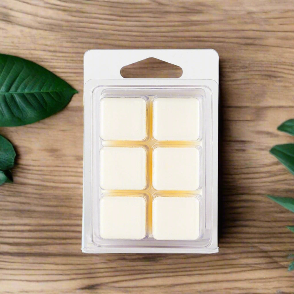 A close-up image of Mahogany Teakwood Soy Wax Melts arranged neatly in their packaging, showcasing their smooth texture and elegant design, crafted with 100% soy wax and scented oils for a clean burn and long-lasting aroma.
