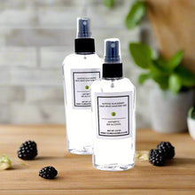 Almond Blackberry Sage Hand Sanitizer Mist bottle with fresh almond, blackberry, and sage leaves in the background